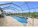 A large screened in pool with pavers and nice landscaping at 8441 Danbury Ln, Hudson, FL 34667
