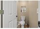 This powder room features a modern toilet, hardwood floors and neutral wall color at 8441 Danbury Ln, Hudson, FL 34667