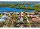 Aerial view emphasizing the home's location amid lush greenery near the serene lake, for premier waterfront living at 944 San Carlos Ne Ct, St Petersburg, FL 33702
