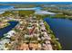 Aerial view showing the home's prime location by the lake amidst lush scenery, promising serene waterfront living at 944 San Carlos Ne Ct, St Petersburg, FL 33702
