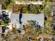 Aerial view showcasing a well-maintained roof, mature trees, and a multi-car driveway at 944 San Carlos Ne Ct, St Petersburg, FL 33702
