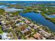 Aerial view highlighting the property's proximity to the serene lake and lush landscaping, offering waterfront living at 944 San Carlos Ne Ct, St Petersburg, FL 33702