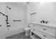White tiled bathroom featuring updated fixtures and modern vanity at 944 San Carlos Ne Ct, St Petersburg, FL 33702