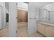 Bathroom view showcasing a tub, vanity, and adjacent hallway access at 944 San Carlos Ne Ct, St Petersburg, FL 33702