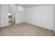 Spacious bedroom with neutral carpeting and view of the attached bathroom at 944 San Carlos Ne Ct, St Petersburg, FL 33702