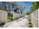 Long, gated driveway lined with lush landscaping, leading to a charming home at 944 San Carlos Ne Ct, St Petersburg, FL 33702