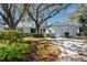 Charming exterior of a home featuring mature landscaping and an attached two-car garage at 944 San Carlos Ne Ct, St Petersburg, FL 33702