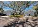 Charming light blue home with well-maintained landscaping and mature trees offering shade at 944 San Carlos Ne Ct, St Petersburg, FL 33702
