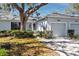 Charming exterior of a home featuring mature landscaping and an attached two-car garage at 944 San Carlos Ne Ct, St Petersburg, FL 33702