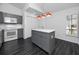 Open kitchen showcasing grey cabinets, a bright white countertop island, white appliances, and ample natural light at 944 San Carlos Ne Ct, St Petersburg, FL 33702