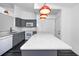Bright kitchen featuring an island with quartz countertop, and grey cabinets with white appliances at 944 San Carlos Ne Ct, St Petersburg, FL 33702