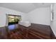 Bright living room featuring hardwood floors, high ceilings, and a sliding glass door to the backyard at 944 San Carlos Ne Ct, St Petersburg, FL 33702
