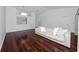 Spacious living room featuring hardwood floors, and a comfortable neutral-toned sofa at 944 San Carlos Ne Ct, St Petersburg, FL 33702