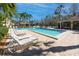 Community pool with lounge chairs and palm trees, ideal for relaxation at 944 San Carlos Ne Ct, St Petersburg, FL 33702