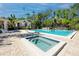 Sparkling pool and jacuzzi surrounded by a patio and tropical landscaping at 944 San Carlos Ne Ct, St Petersburg, FL 33702