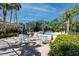 Poolside patio with tables and chairs, perfect for relaxing and enjoying the scenery at 944 San Carlos Ne Ct, St Petersburg, FL 33702