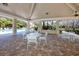 Covered poolside area with seating, perfect for entertaining and enjoying outdoor activities at 944 San Carlos Ne Ct, St Petersburg, FL 33702