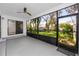 Relaxing screened patio overlooking a well-maintained yard with mature trees and lush landscaping at 944 San Carlos Ne Ct, St Petersburg, FL 33702
