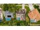 Aerial view of home showcasing the roof and screened in pool and surrounding houses at 1051 Glynwood Pl, Dunedin, FL 34698