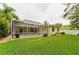 Spacious backyard with a screened-in pool and patio area perfect for outdoor entertaining at 1051 Glynwood Pl, Dunedin, FL 34698