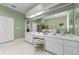 Spacious bathroom with double sinks, vanity, large mirrors, and plenty of cabinet storage at 1051 Glynwood Pl, Dunedin, FL 34698