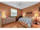Cozy bedroom with hardwood floors, a ceiling fan, and a view of the yard at 1051 Glynwood Pl, Dunedin, FL 34698