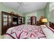 Cozy bedroom with a colorful quilt, wooden furniture, and a sliding glass door to the outdoors at 1051 Glynwood Pl, Dunedin, FL 34698