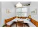 Cozy eat-in kitchen nook is accented by a large window and custom bench seating at 1051 Glynwood Pl, Dunedin, FL 34698