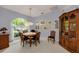 Cozy dining room with a round table, wood furniture, and a large window for natural light at 1051 Glynwood Pl, Dunedin, FL 34698