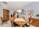 Comfortable dining area featuring a round table and a hutch with views to the living room at 1051 Glynwood Pl, Dunedin, FL 34698