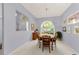 Cozy dining room featuring a round table, arched window, and neutral-toned carpet at 1051 Glynwood Pl, Dunedin, FL 34698