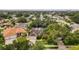 Aerial view of home showcasing the lawn and mature trees surrounding the home at 1051 Glynwood Pl, Dunedin, FL 34698