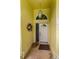 Inviting entryway with a white front door, decorative wreath, and neutral-toned tile flooring at 1051 Glynwood Pl, Dunedin, FL 34698
