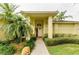 Inviting front entrance featuring a well-maintained walkway and lush landscaping at 1051 Glynwood Pl, Dunedin, FL 34698