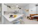 Bright white kitchen featuring a spacious island, modern appliances, and ample counter space at 1051 Glynwood Pl, Dunedin, FL 34698
