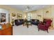 Comfortable living room with a fireplace, tile flooring, and a bright window view to the outside at 1051 Glynwood Pl, Dunedin, FL 34698
