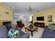 The living room features a fireplace, tv, and an open layout to the kitchen at 1051 Glynwood Pl, Dunedin, FL 34698