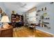 Dedicated office space with built-in shelving, hardwood floors, and ample desk space at 1051 Glynwood Pl, Dunedin, FL 34698