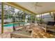 Screened in patio with outdoor seating next to the pool, perfect for enjoying the outdoors at 1051 Glynwood Pl, Dunedin, FL 34698