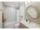 Updated bathroom features a modern vanity, shower with tub, and decorative mirror at 106 W Minnehaha St, Tampa, FL 33604