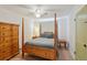 Bedroom showcasing wooden bed frame, neutral decor and window at 106 W Minnehaha St, Tampa, FL 33604