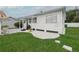 Exterior view of a bright home with white siding, a well-manicured lawn, and a small porch at 106 W Minnehaha St, Tampa, FL 33604