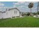 Well-maintained home with a lush green lawn, vibrant landscaping, and a classic white picket fence at 106 W Minnehaha St, Tampa, FL 33604