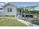 Charming home with a welcoming yellow door and meticulously landscaped front yard at 106 W Minnehaha St, Tampa, FL 33604