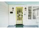 Close-up of the front door of a lovely home with outdoor lanterns and a stylish yellow door at 106 W Minnehaha St, Tampa, FL 33604