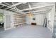 Bright garage interior with painted beams, ample storage shelves, and hanging pendant light at 106 W Minnehaha St, Tampa, FL 33604