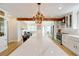 A kitchen featuring a very large island, stainless steel appliances, and a decorative wooden beam at 106 W Minnehaha St, Tampa, FL 33604