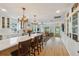 A kitchen featuring an island with seating, an open floorplan, glass front cabinetry, and a farmhouse sink at 106 W Minnehaha St, Tampa, FL 33604