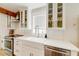 A kitchen showcasing a farmhouse sink, stainless steel appliances, and glass-front cabinets at 106 W Minnehaha St, Tampa, FL 33604