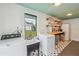 Laundry room with modern washer and dryer, ample counter space, and stylish tile floors at 106 W Minnehaha St, Tampa, FL 33604